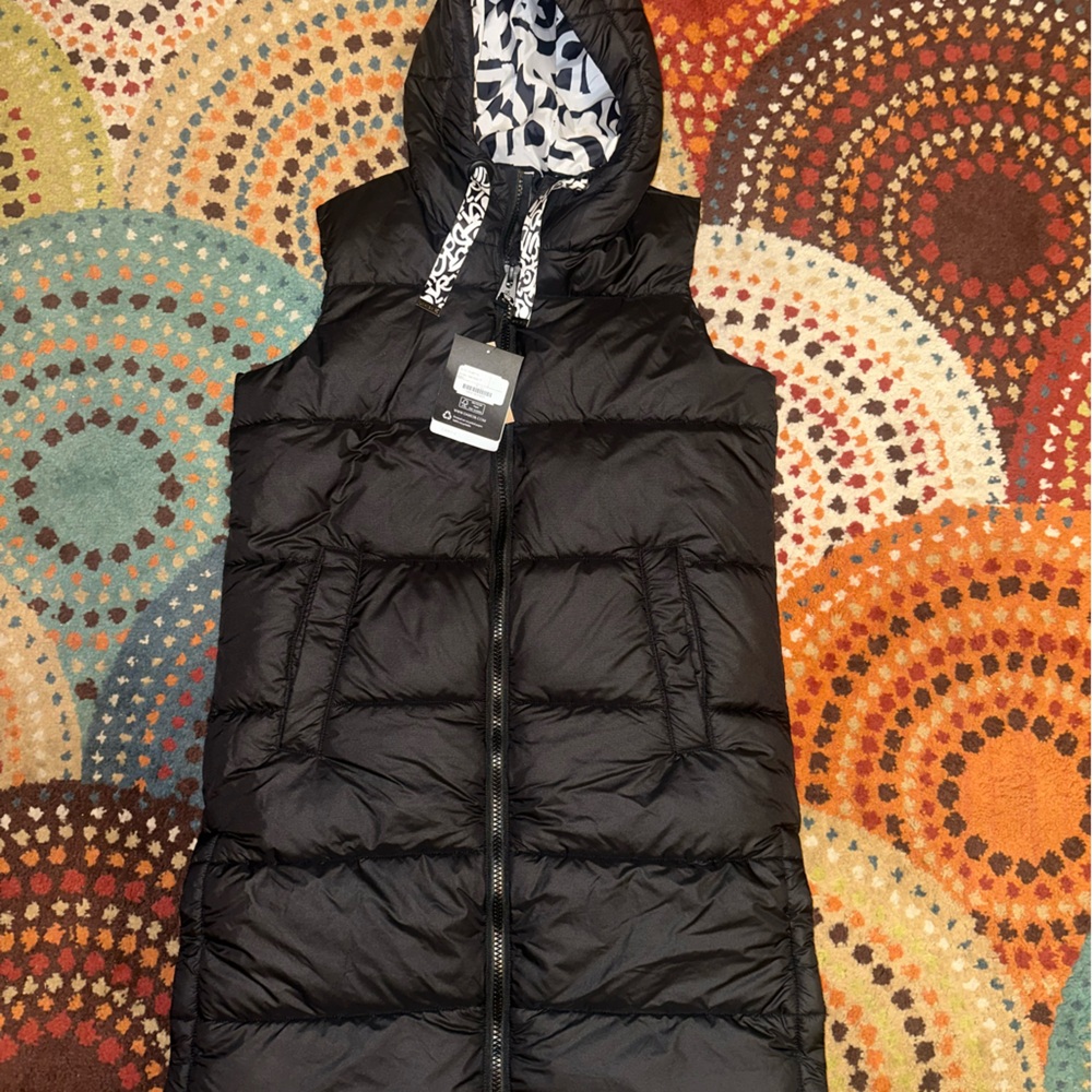 Woman’s black stylish Puffer Vest with Patterned Hood. Classy dress up or down.